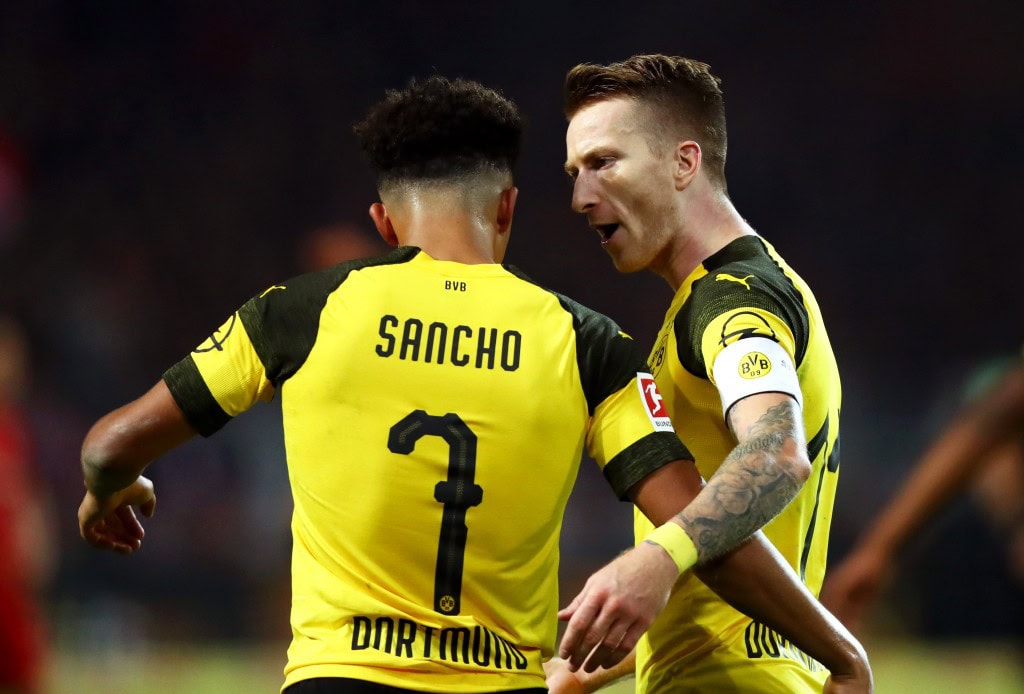DORTMUND, GERMANY - NOVEMBER 10: Marco Reus of Borussia Dortmund celebrates with teammate Jadon Sancho after scoring his team's second goal during the Bundesliga match between Borussia Dortmund and FC Bayern Muenchen at Signal Iduna Park on November 10, 2018 in Dortmund, Germany. (Photo by Dean Mouhtaropoulos/Bongarts/Getty Images)